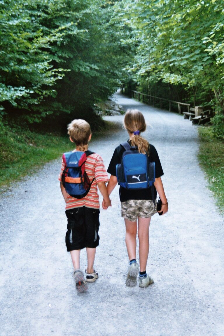 Two small children walking away