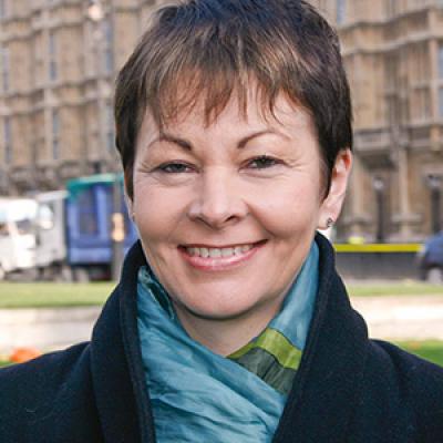 Caroline Lucas in front of the Houses of Parliament.