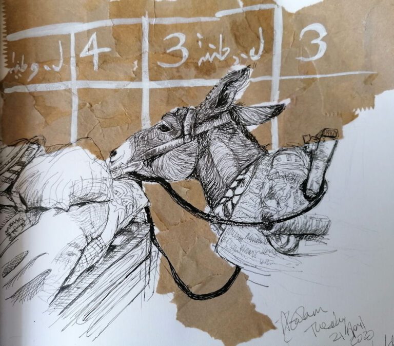 A donkey sniffing a cart