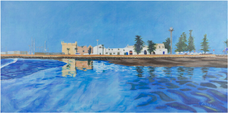 A very blue image of sea, a shoreline with buildings, and sky