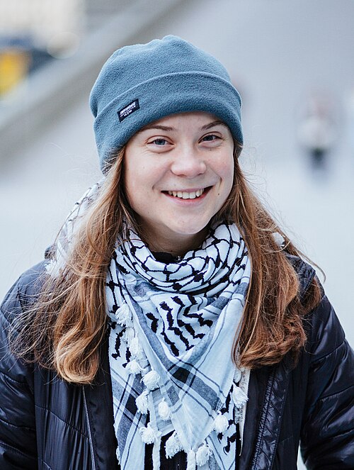 Greta Thunberg in a keffiyeh and a beanie