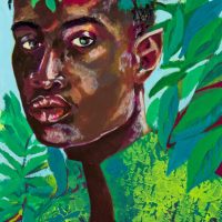 A young Black man surrounded by green foliage
