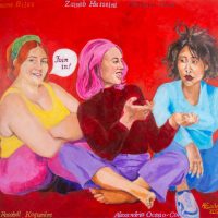 Three women sit on the floor, talking