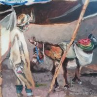 A man standing by a laden donkey